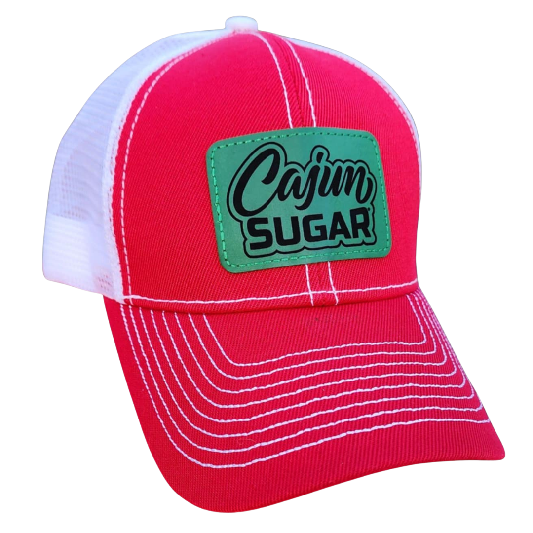 Red cap with a green patch labeled 'Cajun Sugar' on a white background